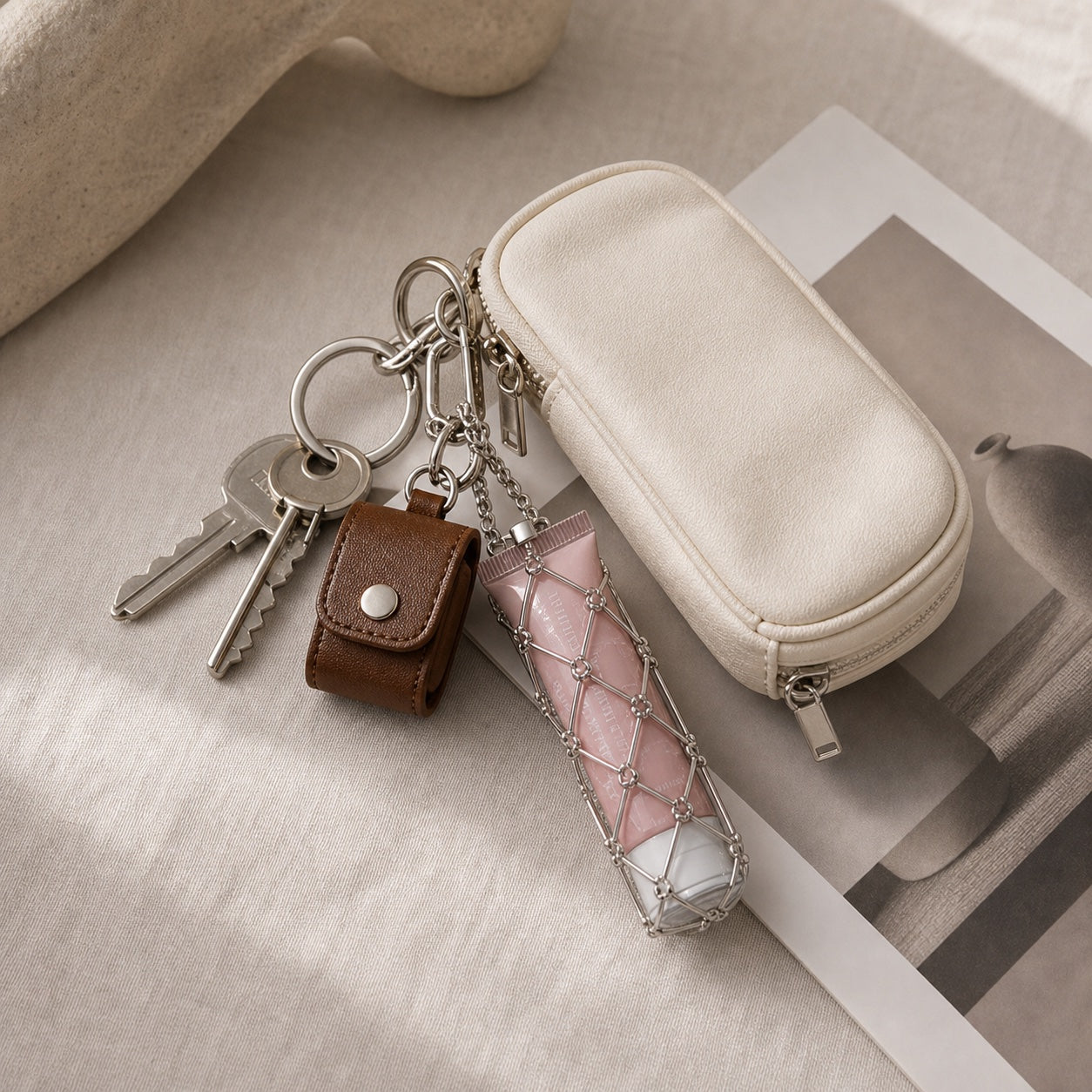 Utility charms clipped to keys and a small travel pouch