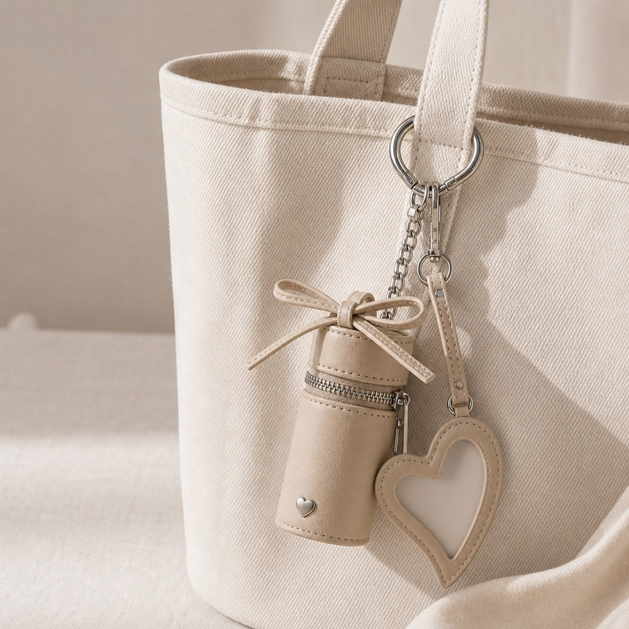 Beige cylindrical small-things holder clipped to a cream canvas tote
